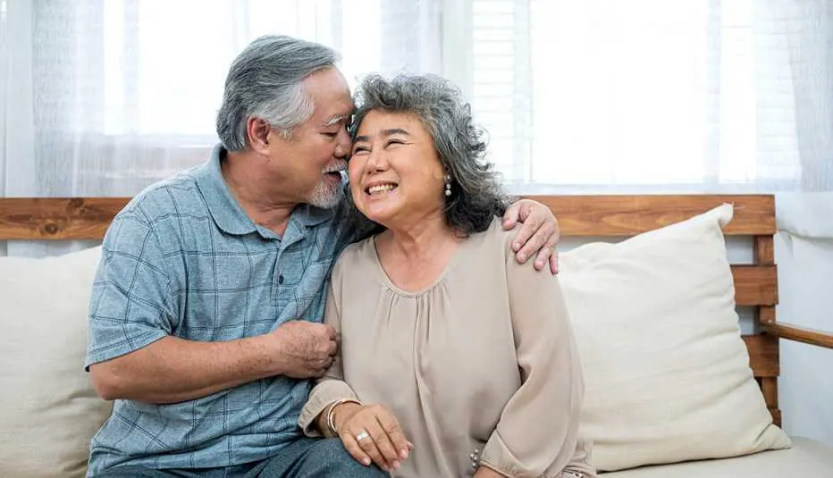 Senior couple laughing together at home